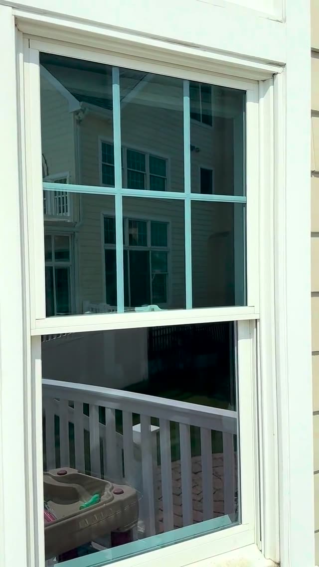 A window pane going from hazy and spotted to clear glass