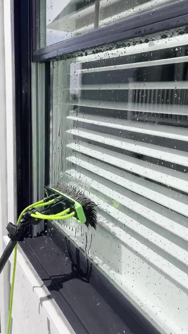 Water-fed brush cleaning a window pane and frame with pure water